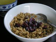 Granola cereal with almond milk, cranberries, and green tea